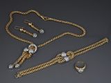 a collection of gold and diamond jewelry including a necklace, bracelet, and ring