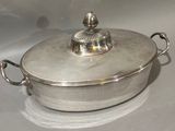 a silver pot with a lid on a white table
