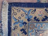 a blue and yellow rug with a blue design on it