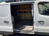 a white van with its doors open in a parking lot