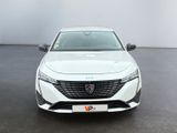 the front view of a white car in a white room