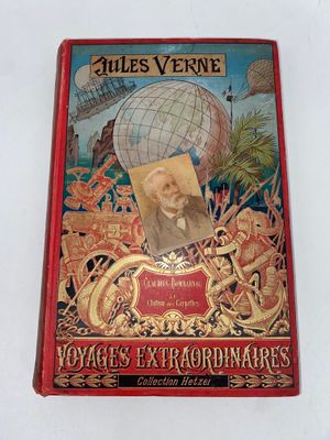 an old book with a picture of a man in a globe on the cover