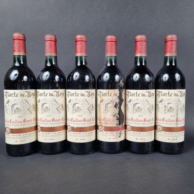 six bottles of red wine are lined up in a row