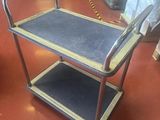 a metal cart with a handle on it in a warehouse