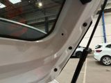 a white car parked in a parking lot next to other cars