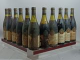 bottles of wine are lined up on a wooden tray