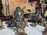 a lot of bronze figurines sitting on a table