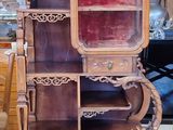 a tall wooden cabinet with a mirror on top of it