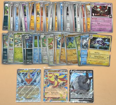 beaucoup de cartes pokemon différentes sur la table
