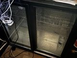 an image of a computer desk with a glass door