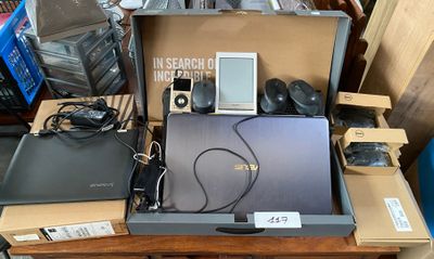 a laptop, mp3 player, and other electronics on a table