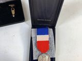 a small medal in a small box on a table