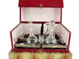 a red box with a set of wine glasses and a decanter in it