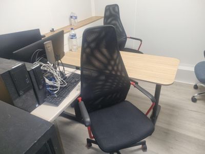 a desk with a chair and a computer on it