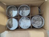 six buckets of shredded paper in a cardboard box