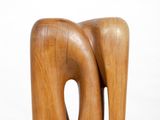 sculpture of a wooden elephant on a white pedestal