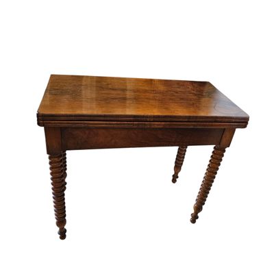 an old wooden table with turned legs on a white background