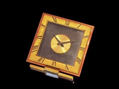 a clock that is sitting on top of a wooden box