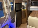 a refrigerator and a refrigerator freezer in a small room