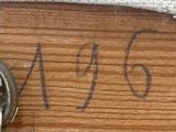 a picture of a ring on a piece of wood that has writing on it
