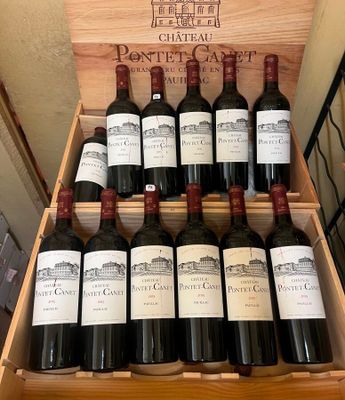 bottles of red wine in a wooden case on display in a store