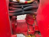 a close up of a red fire hydrant with a hose