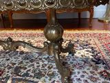 a table that is sitting on a rug on the floor