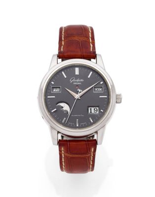 gros plan d'une montre sur une surface blanche avec un bracelet marron