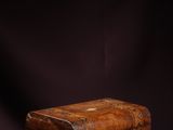 an old wooden box sitting on top of a purple surface
