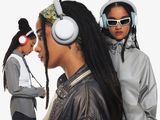 two women standing next to each other with headphones on