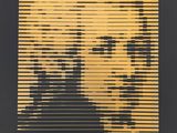 a black and gold poster with a picture of a man ' s face