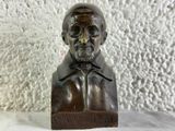 statue of a bust of a man with a beard and a hat