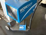 a blue machine that is sitting in a garage