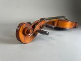 an old violin sitting on top of a table next to a wall