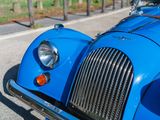 a blue car parked on the side of the road