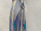 an image of a dress on a mannequin stand in front of a white backdrop