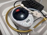 wires and plugs connected to a water heater in a bathroom