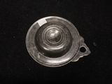 a metal object with a hole in it on a black surface