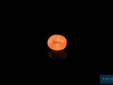 an orange moon in the dark sky with a reflection on the ground
