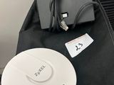 a black bag and a white device on a table