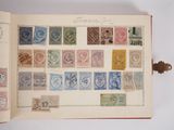 an open book with stamps on it sitting on a table