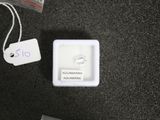 a small white box with a ring on top of it