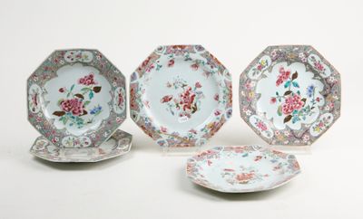 three plates with floral designs on them sitting next to each other