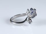 a close up of a silver ring with blue and white stones