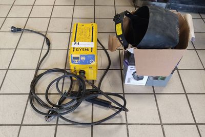 a box of wires on the floor next to a box of wires