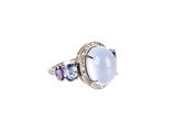 a close up of a ring with blue and purple stones