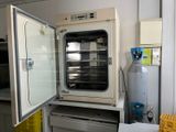 an open oven sitting in the middle of a kitchen