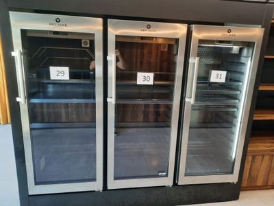 three glass doors that are open in a store