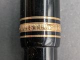 an image of a close up of a pen with a ring on it