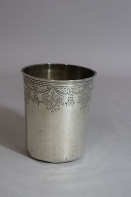 une tasse en argent antique avec un motif floral sur le bord